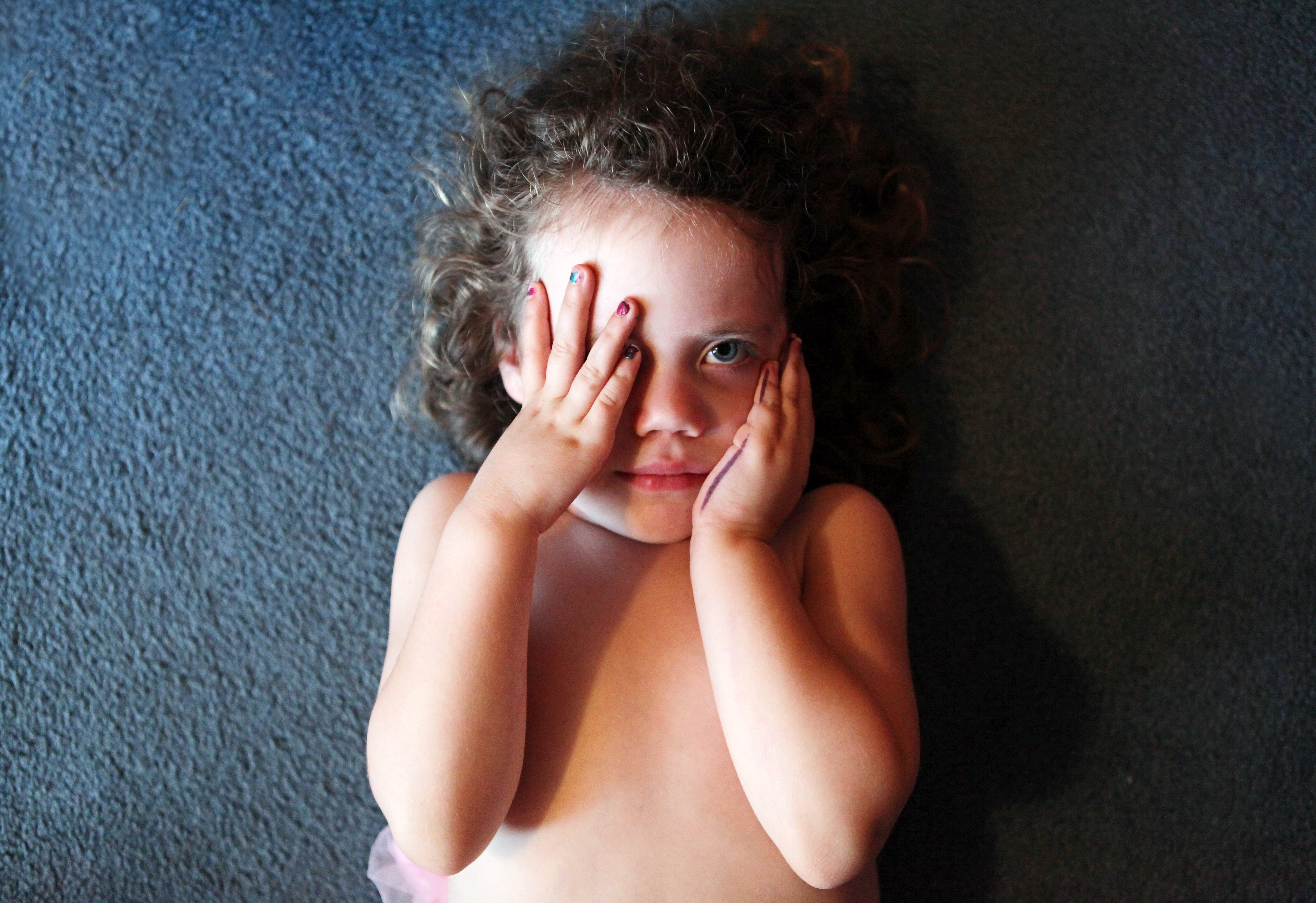 child covering one eye