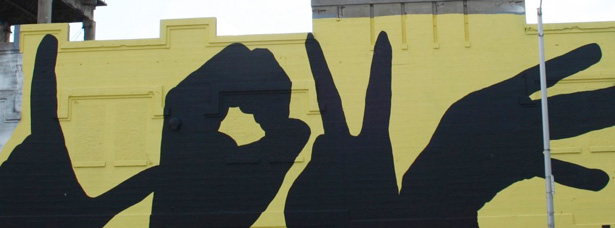 grief mural of hand silhouettes spelling out the word "love"